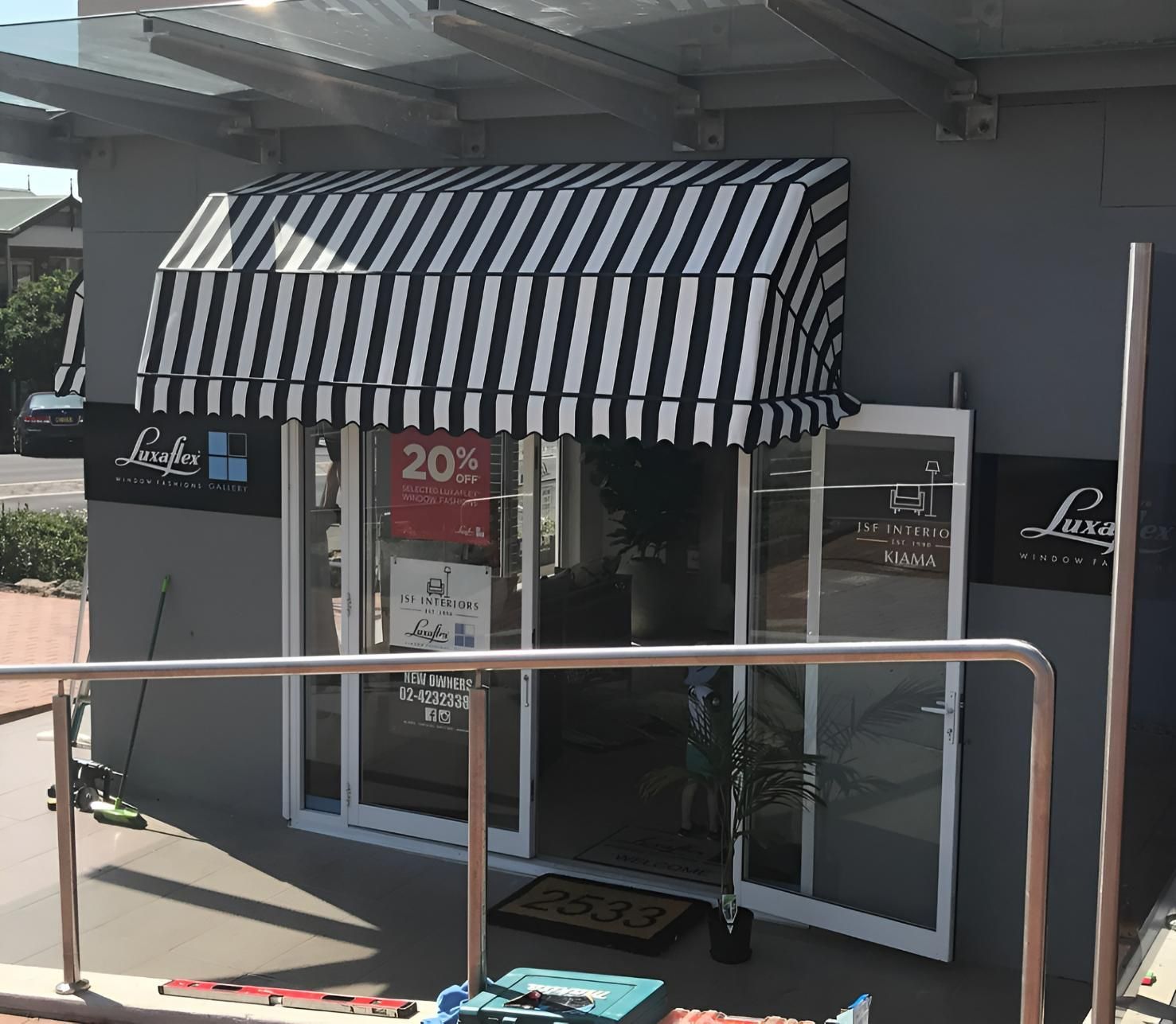 Shop Exterior With Black And White Striped Awning — JSF Interiors Goulburn in Southern Highlands, NSW