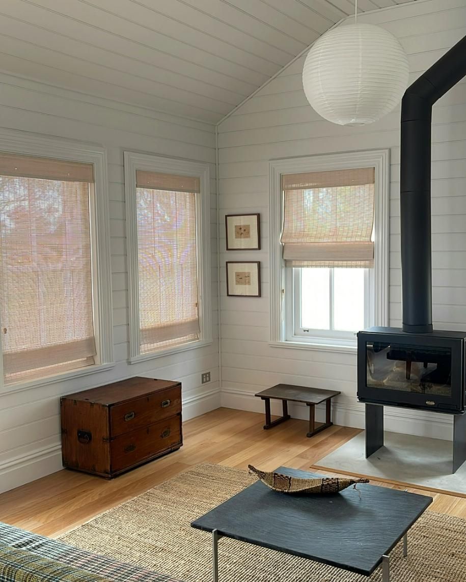 Cozy Living Room With Wood Stove And Woven Shades — JSF Interiors Goulburn In Kiama, NSW
