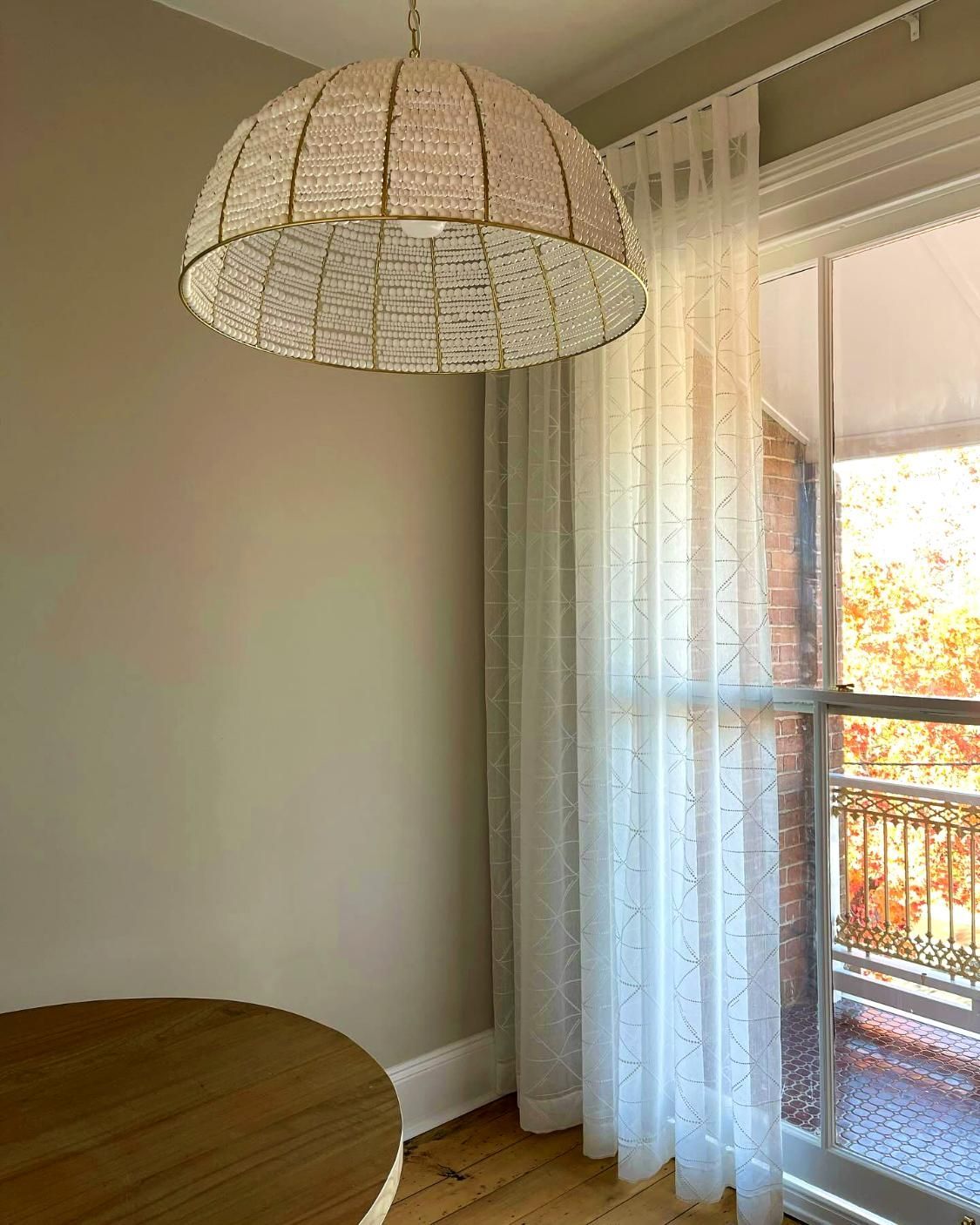 Beaded Pendant Light Over Wooden Table — JSF Interiors Goulburn in Albion Park, NSW