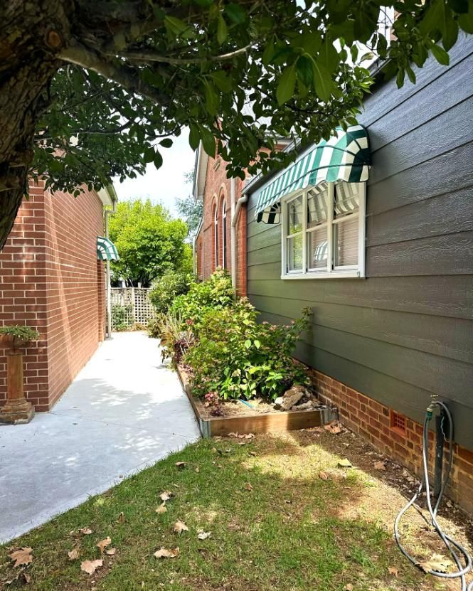 Narrow Pathway Between Buildings With Garden Bed And Awning — JSF Interiors Goulburn in Dapto, NSW