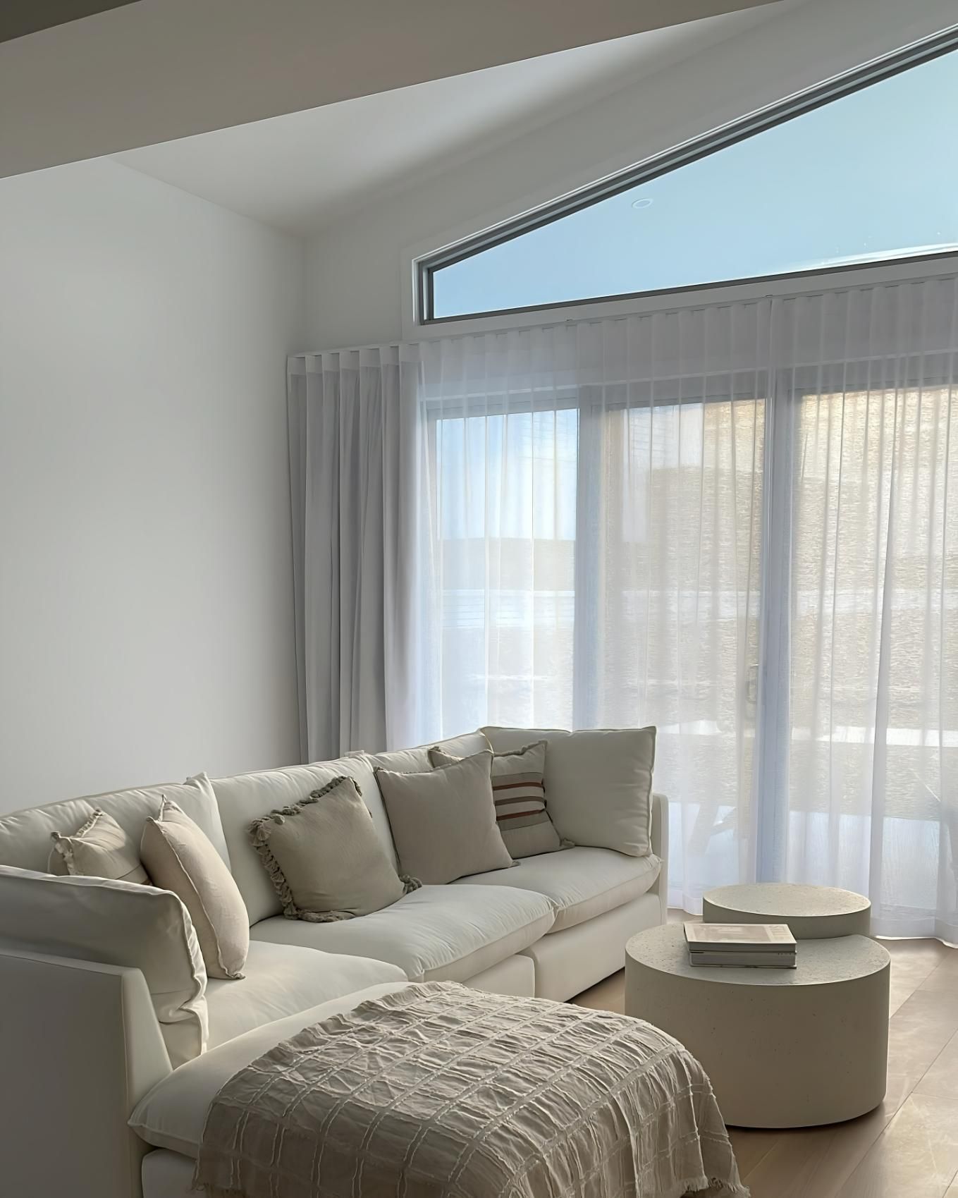 Bright Living Room With White Sectional Sofa And Sheer Curtains — JSF Interiors Goulburn in Goulburn, NSW