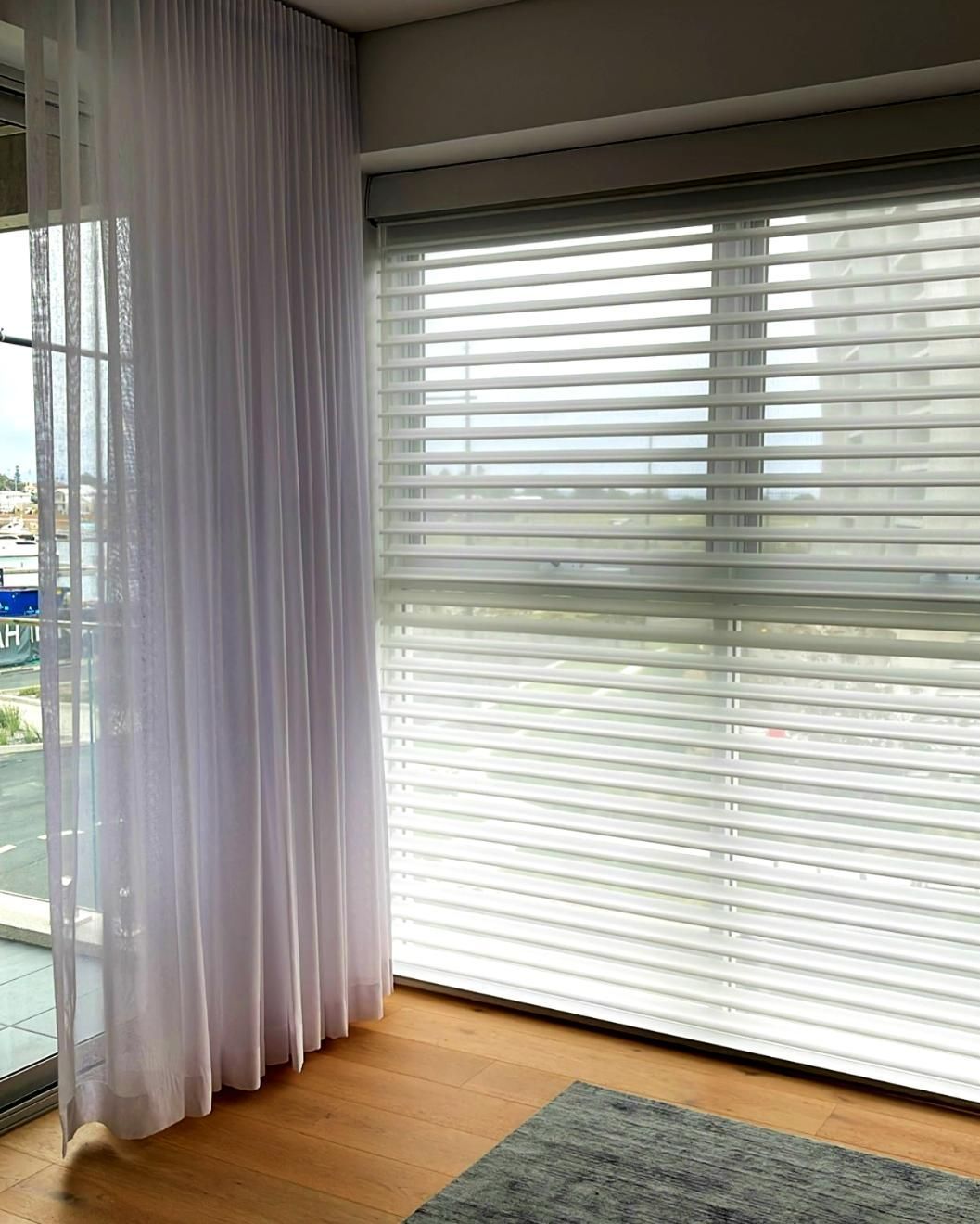 Sheer White Curtains And Blinds With City View — JSF Interiors Goulburn in Bowral, NSW