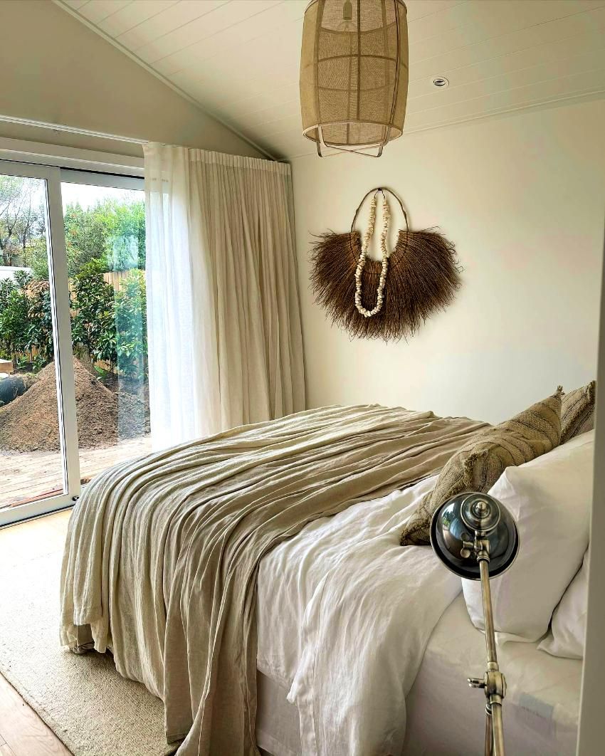 Bedroom With Neutral Tones, Textured Throw, Sliding Glass Door — JSF Interiors Goulburn in Gerringong, NSW