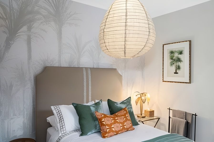 Bedroom With Palm Tree Wallpaper And Green Orange Pillows — JSF Interiors Goulburn in Goulburn, NSW