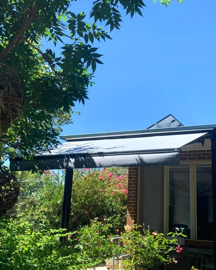 Awning Over Brick Home Patio With Green Foliage — JSF Interiors Goulburn in Berry, NSW