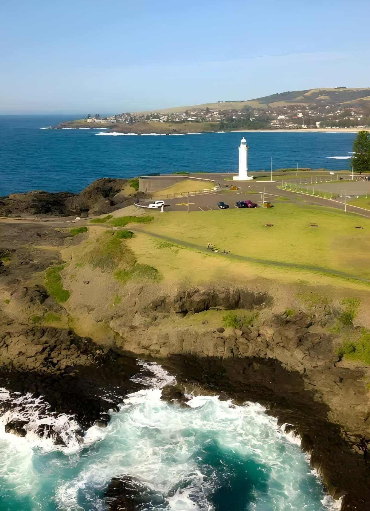 Coastal View With Lighthouse On Grassy Cliff — JSF Interiors Goulburn in Kiama, NSW