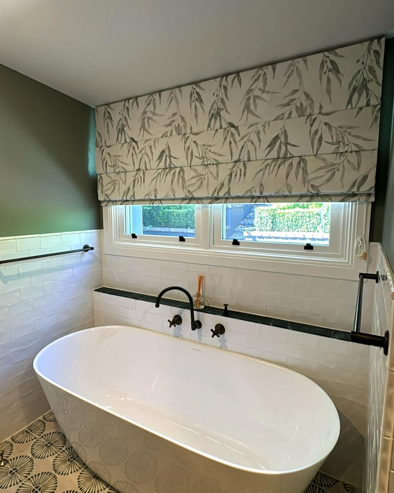 Bathroom With White Soaking Tub And Patterned Roman Shade — JSF Interiors Goulburn in Goulburn, NSW