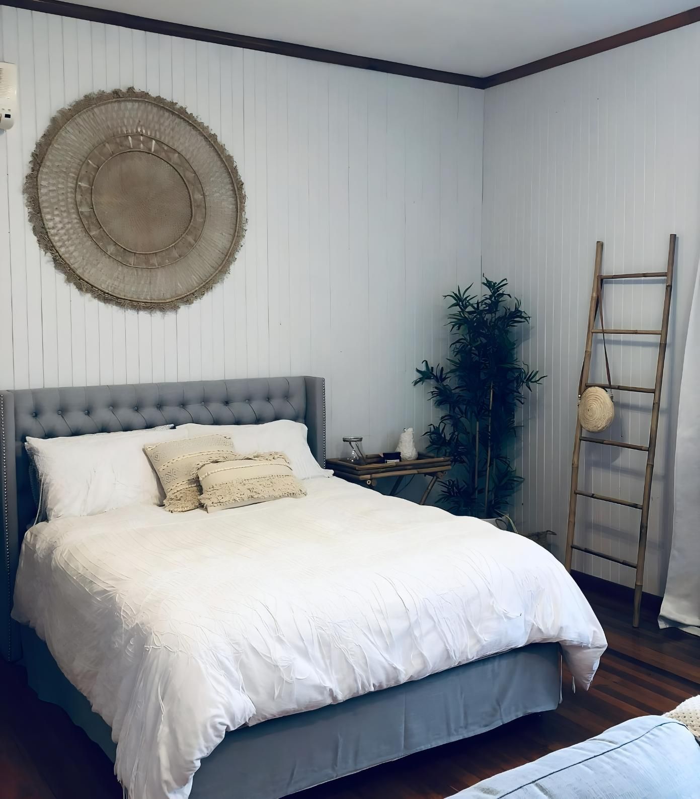 Cozy Bedroom With Gray Bed And White Bedding — JSF Interiors Goulburn in Goulburn, NSW