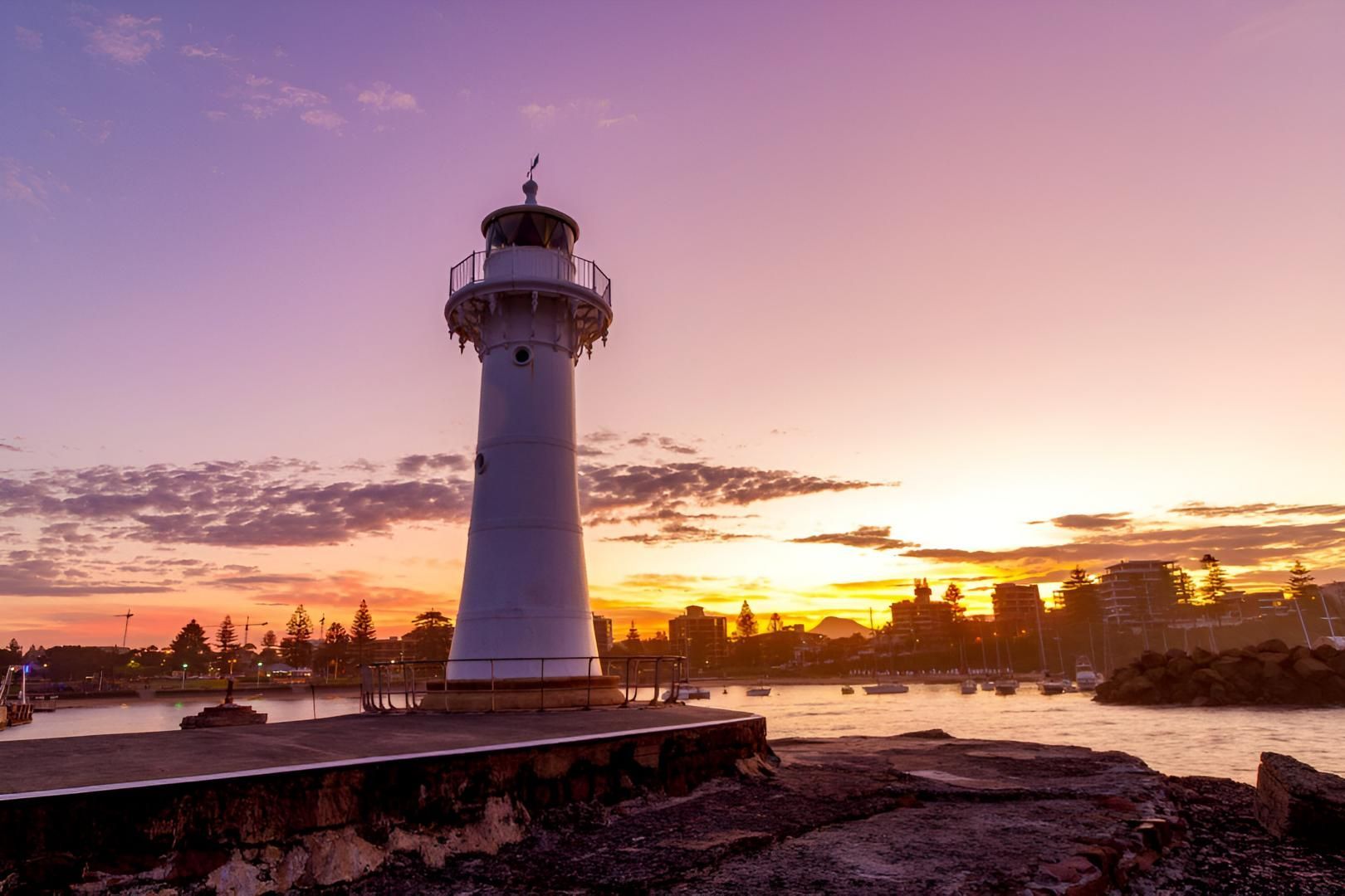 White Lighthouse At Sunset With Purple And Orange Sky — JSF Interiors Goulburn in Wollongong, NSW