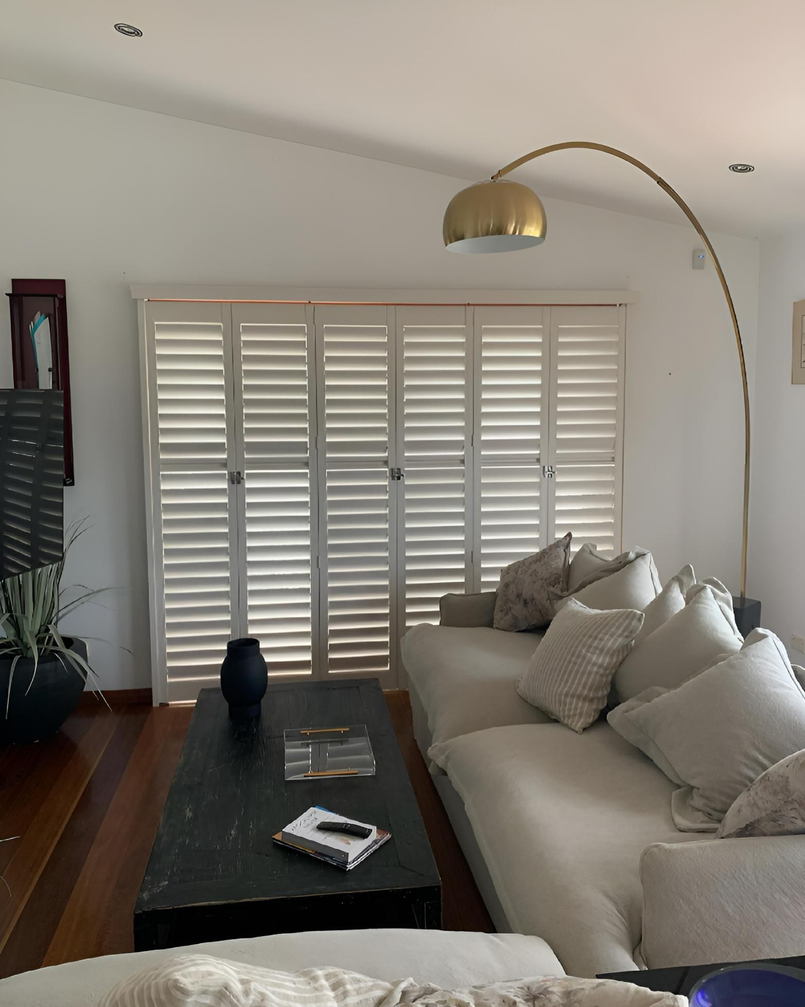 Living Room With Light Shutters Couch And Coffee Table — JSF Interiors Goulburn in Albion Park, NSW