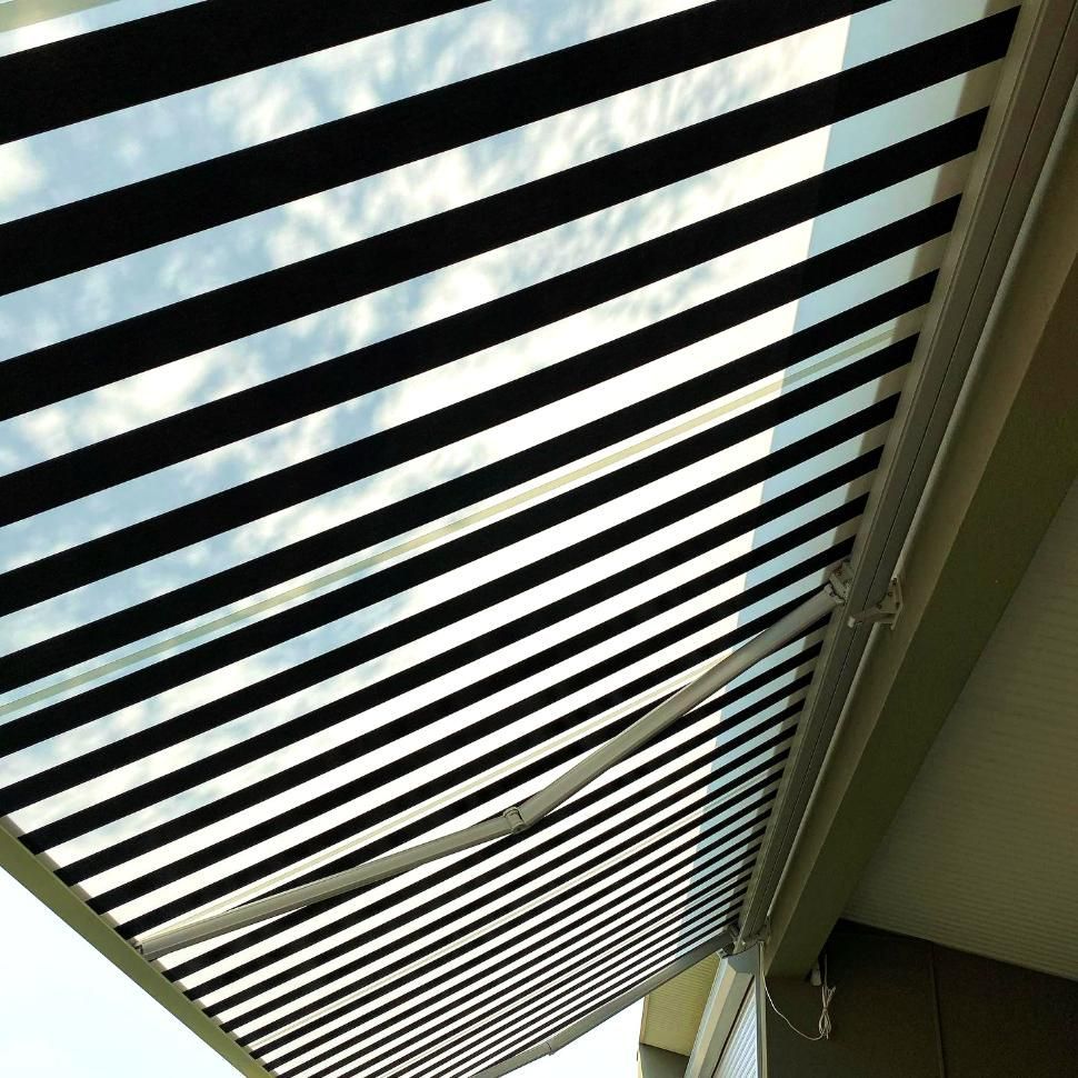 Black And White Striped Awning On Patio — JSF Interiors Goulburn in Shellharbour, NSW