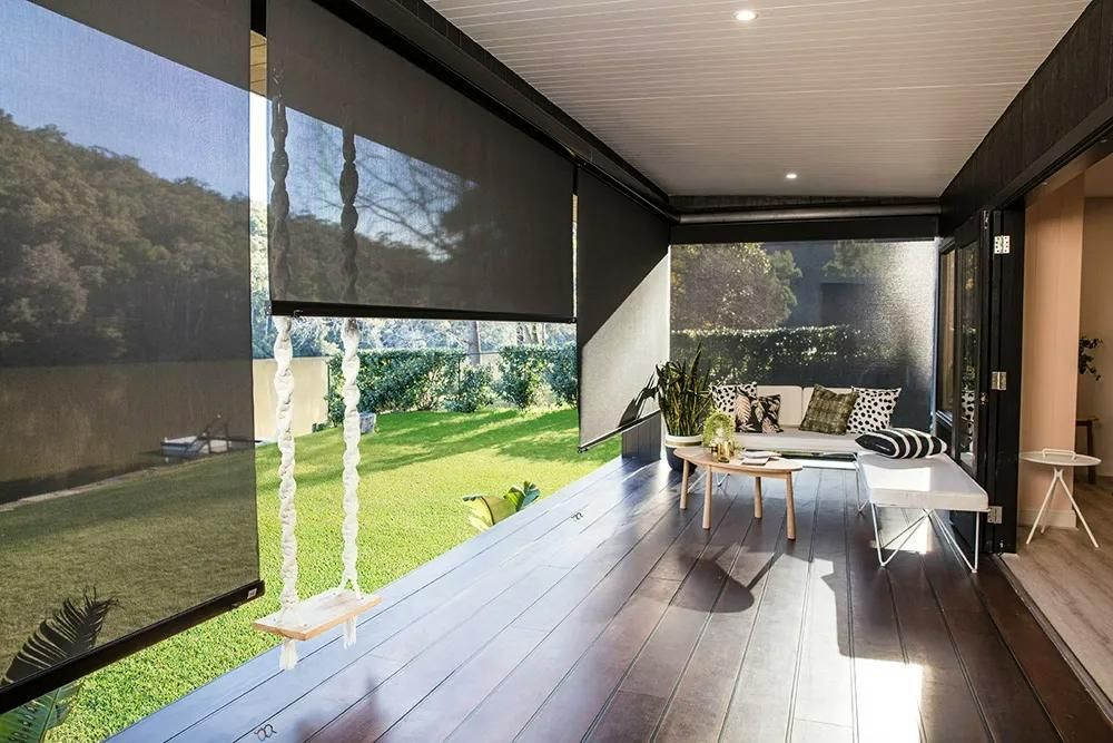 Outdoor Patio With Roller Shades And Swing Couch — JSF Interiors Goulburn in Goulburn, NSW