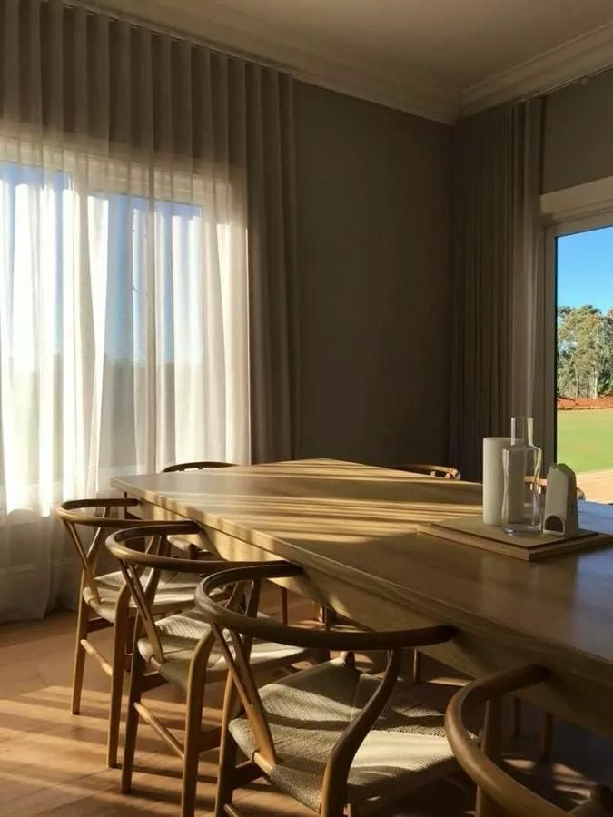 Dining Room With Wooden Table And Sheer Curtains — JSF Interiors Goulburn in Goulburn, NSW