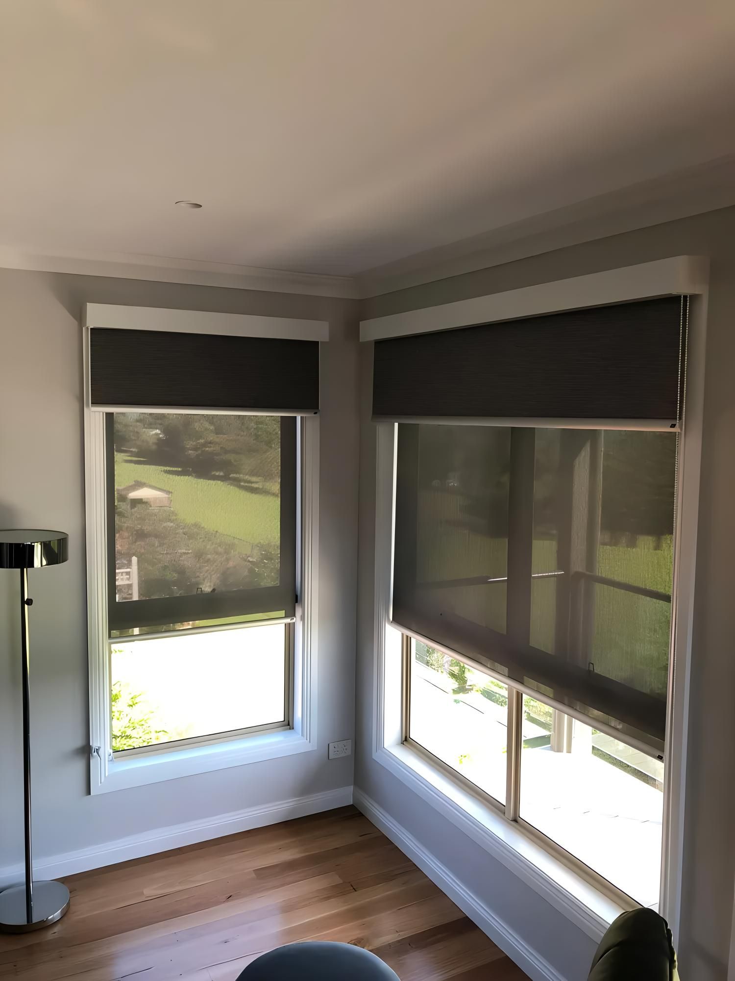 Corner Windows With Dark Gray Roller Blinds — JSF Interiors Goulburn in Goulburn, NSW