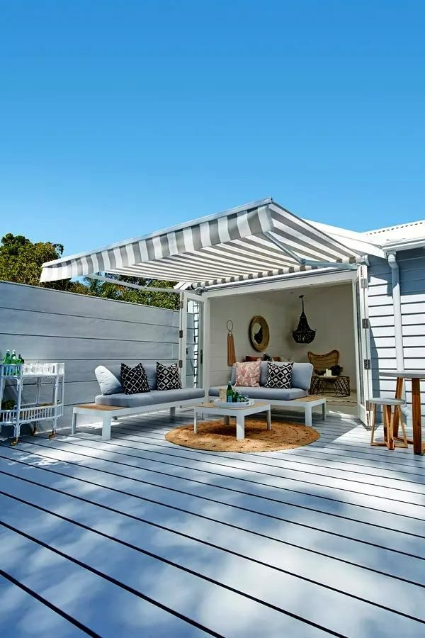 Outdoor Deck With Striped Awning And Light Furniture — JSF Interiors Goulburn in Goulburn, NSW