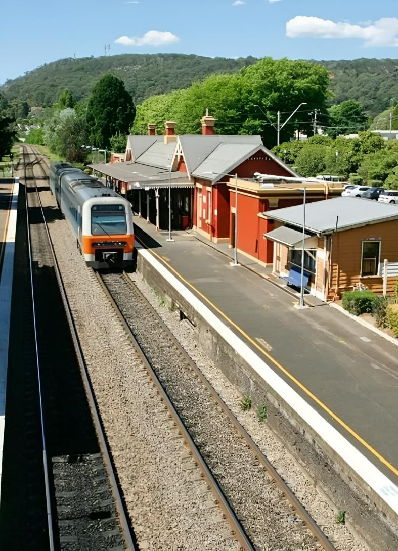 Train Arriving At Station With Red Buildings — JSF Interiors Goulburn in Southern Highlands, NSW