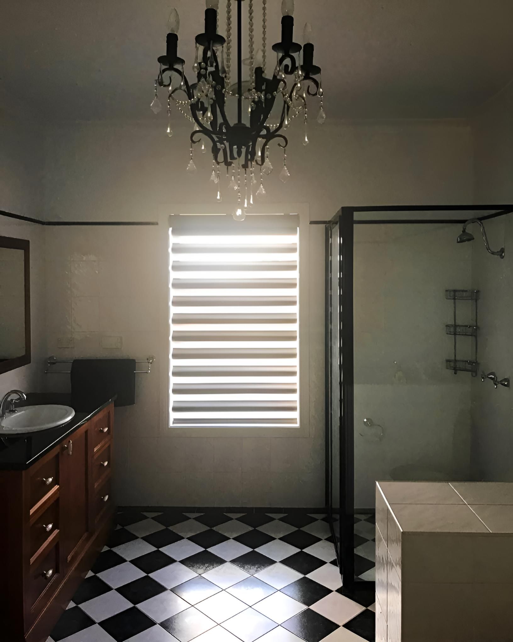 Bathroom With Checkered Floor And Chandelier — JSF Interiors Goulburn in Shellharbour, NSW