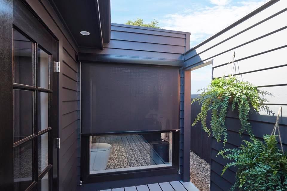 Black exterior with shade-covered window, plants hanging on the wall — JSF Interiors Goulburn in Goulburn, NSW