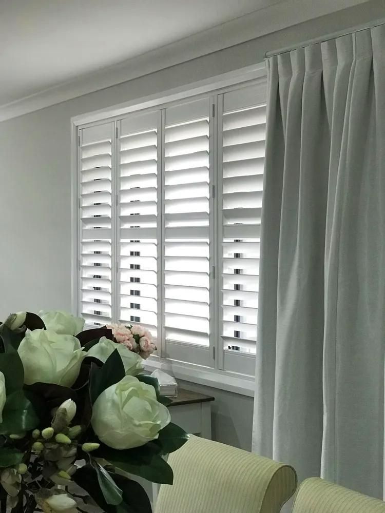 White Shutters And Gray Curtains With Flower Arrangement — JSF Interiors Goulburn in Goulburn, NSW