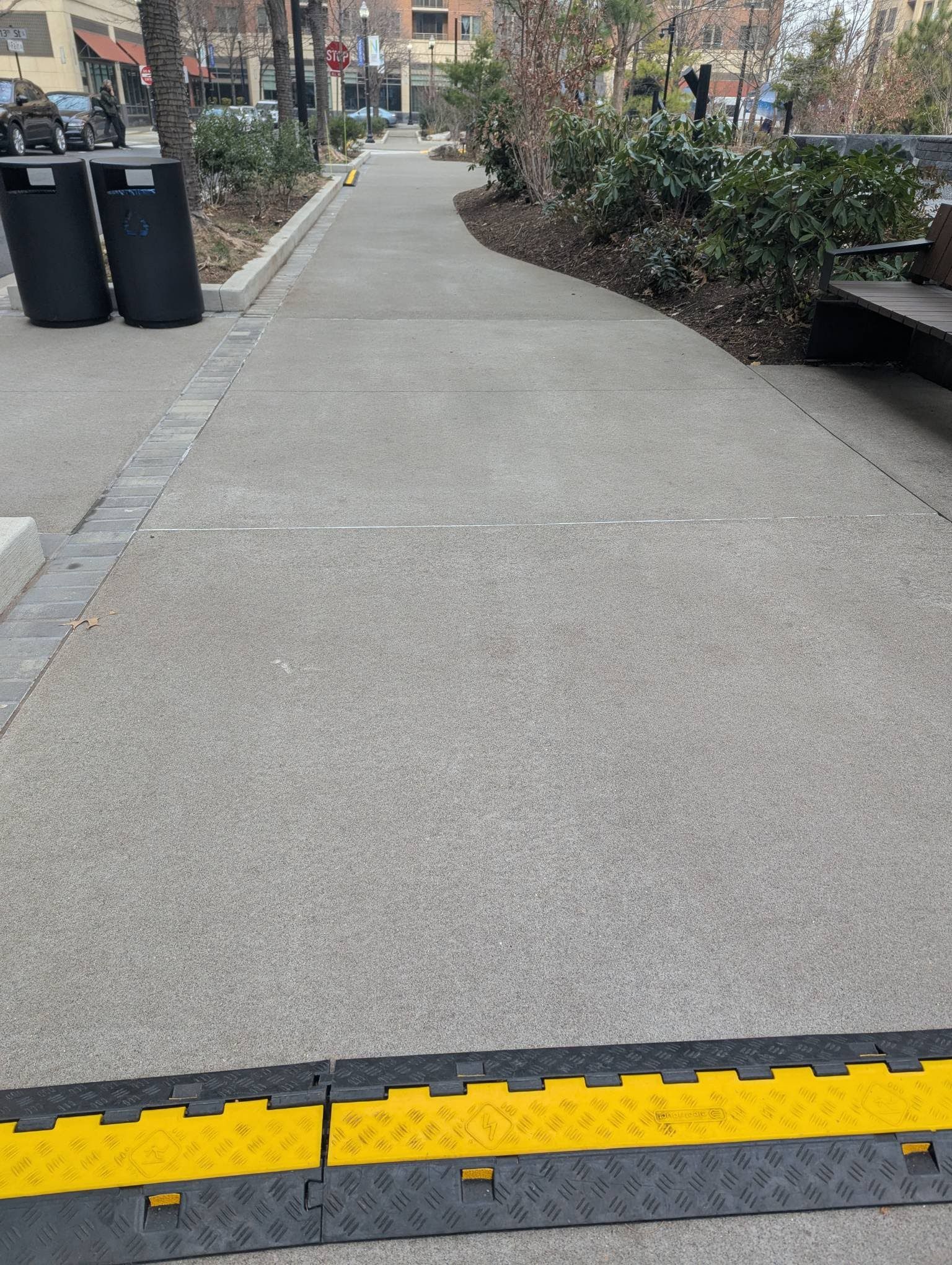 A group of construction workers are working on a concrete walkway.
