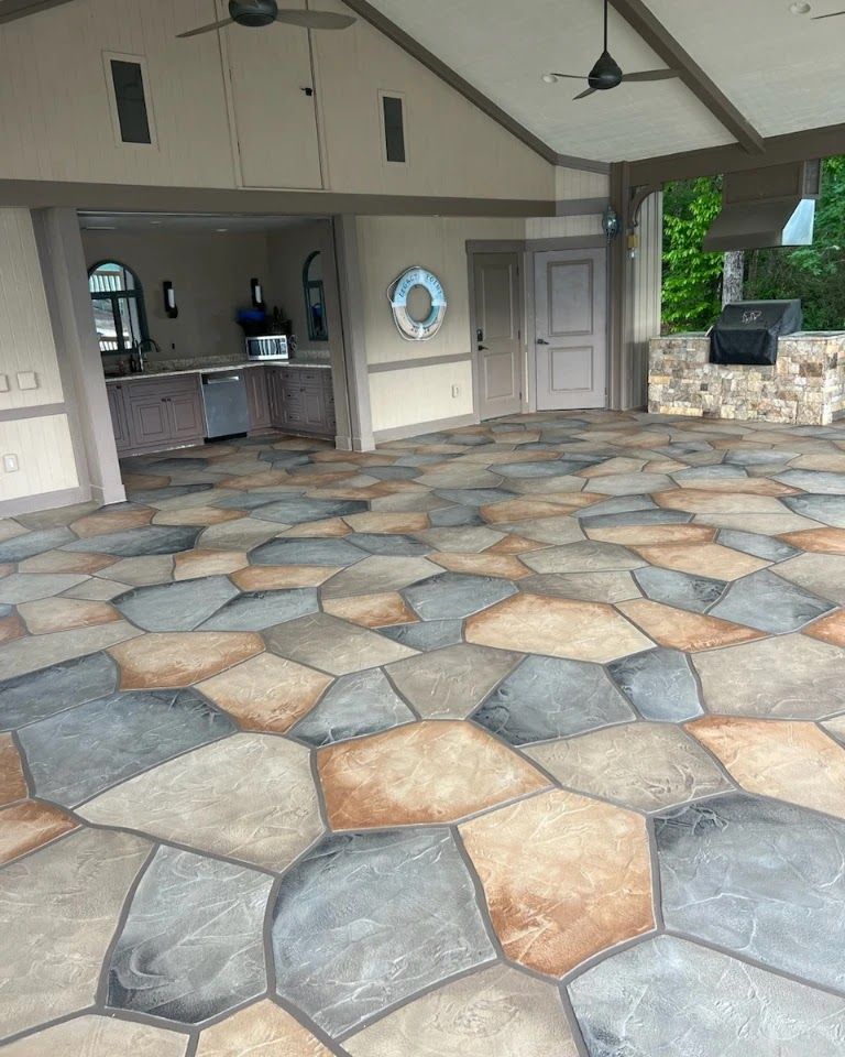 A concrete walkway in a park surrounded by green grass and trees.