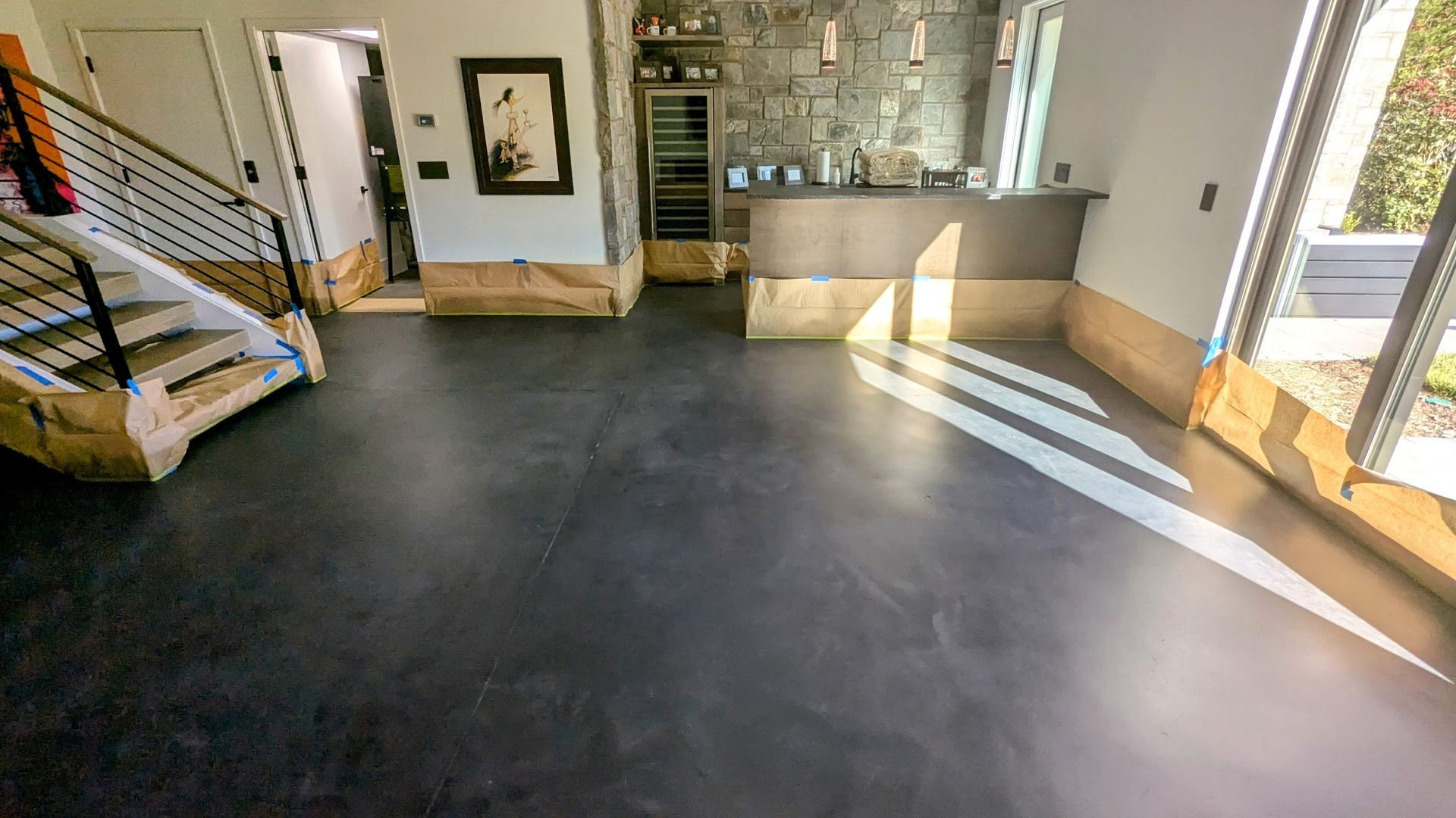 A concrete walkway in a park surrounded by green grass and trees.