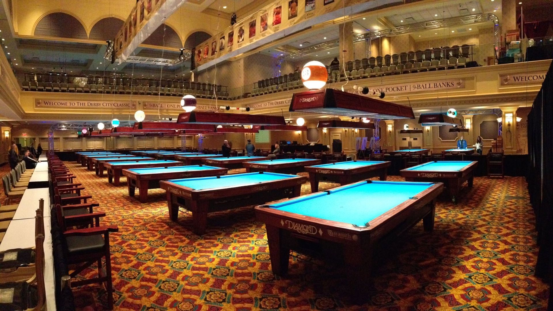 A pool hall filled with pool tables and chairs