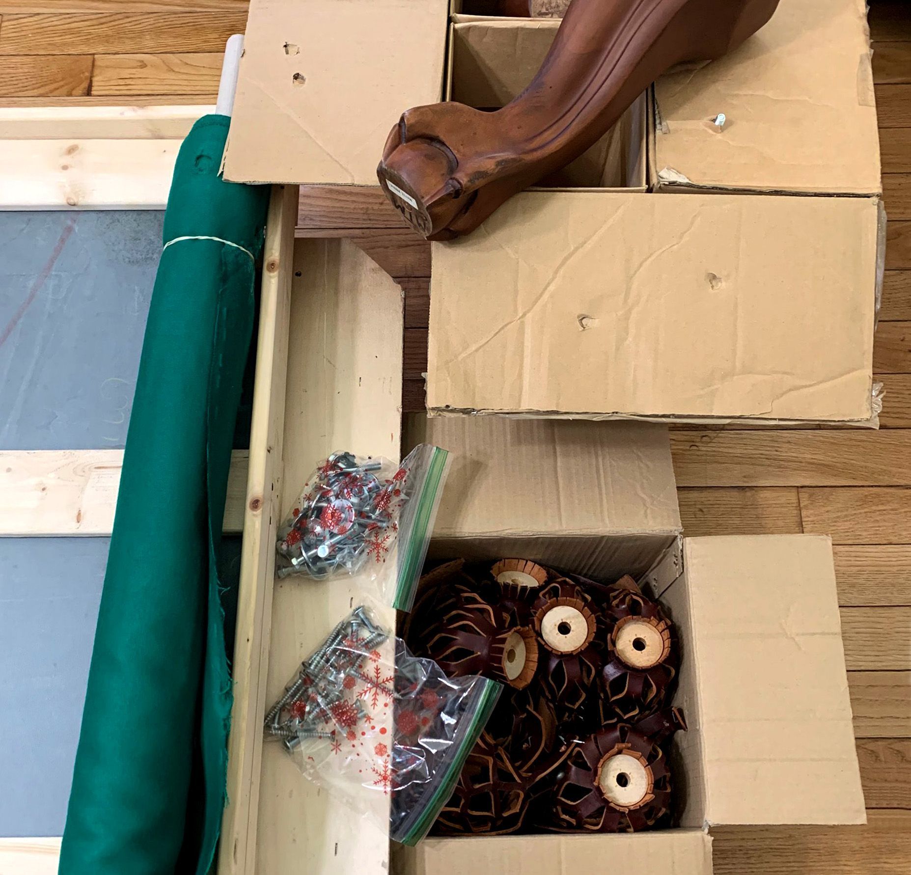 A box of donuts sits on a wooden table