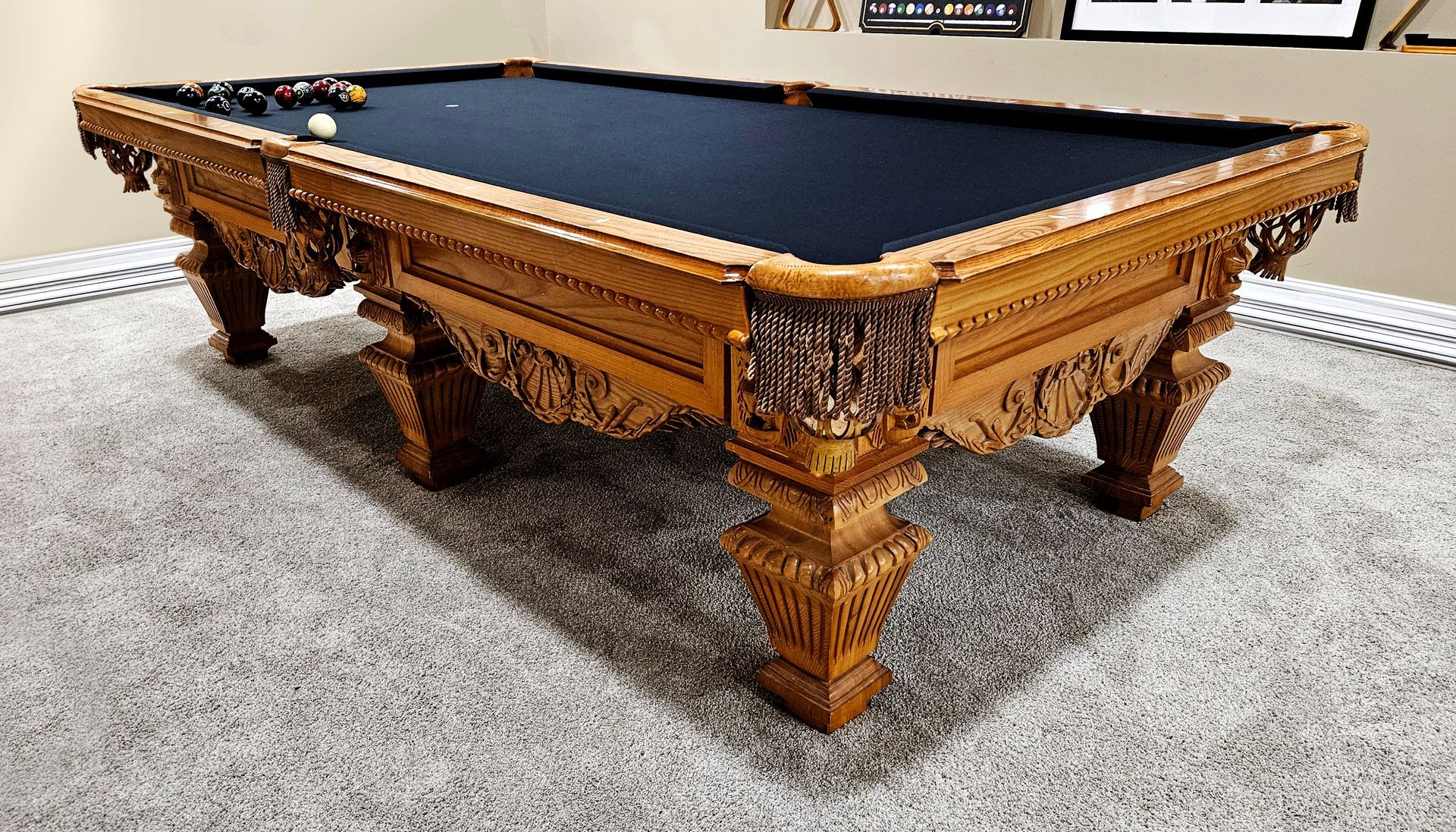A pool table is sitting on a carpeted floor in a room.
