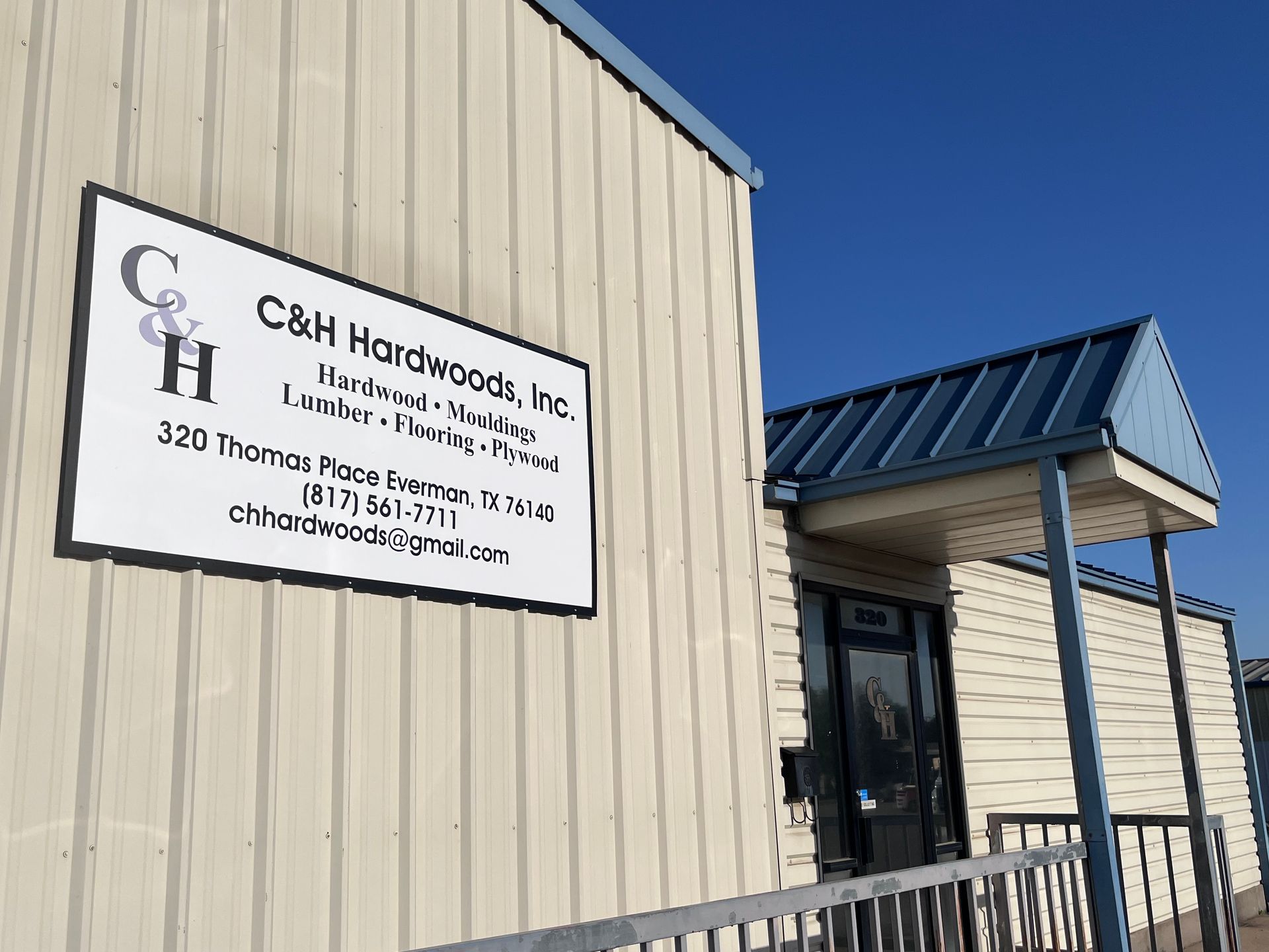 Sign for C&H Hardwoods, Inc. on a tan building, located at 320 Thomas Place, Denison, TX.