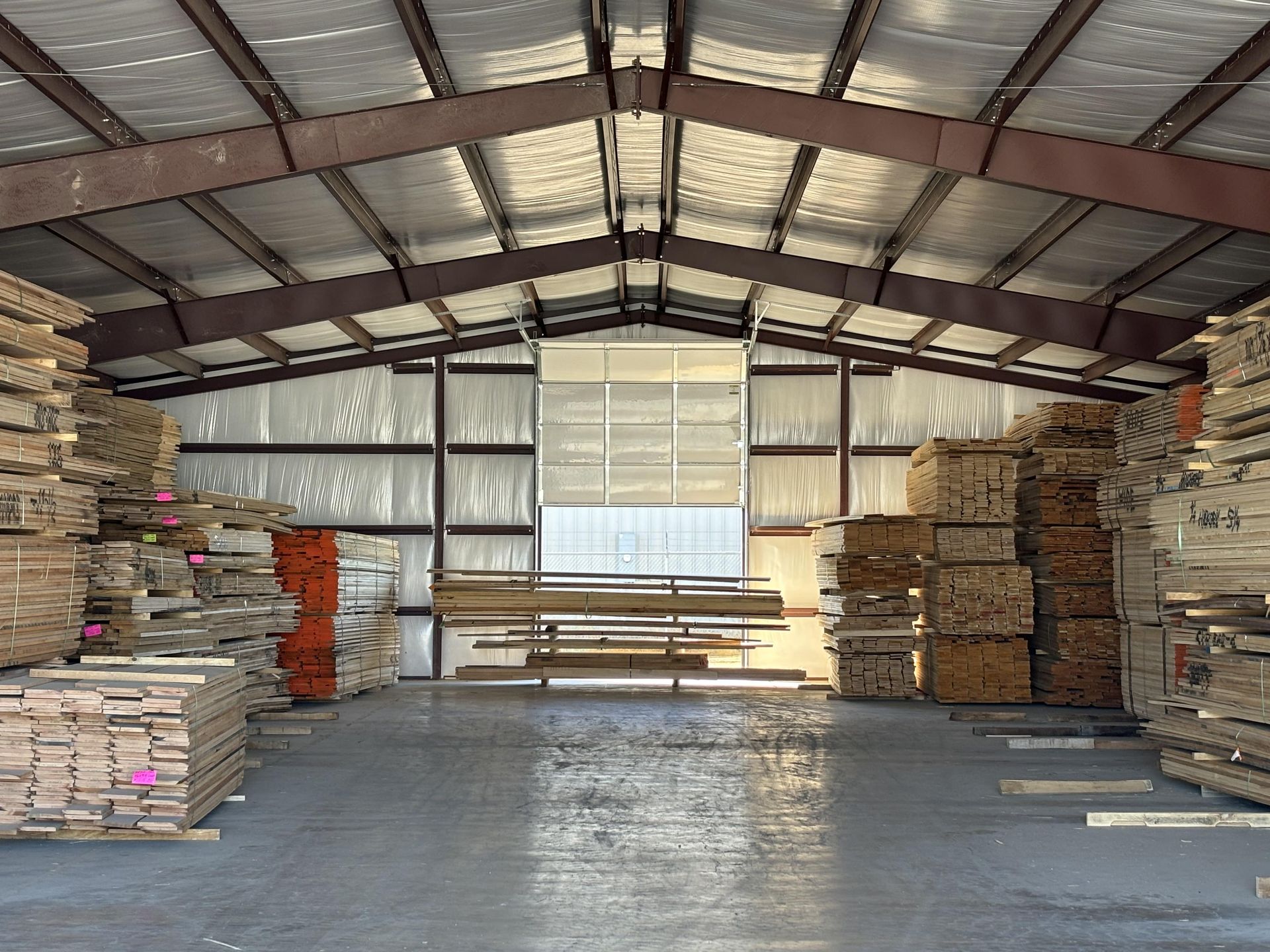 A large warehouse filled with lots of wooden pallets