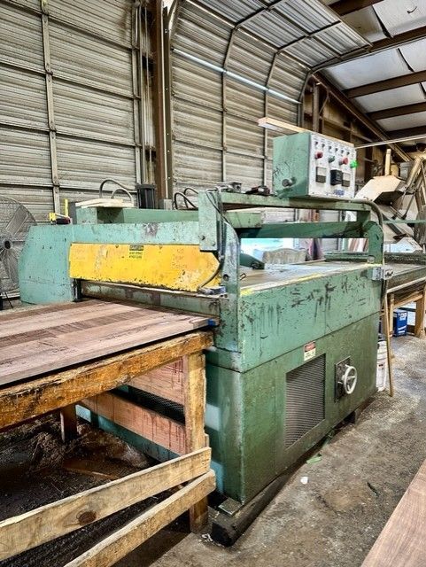 A machine is sitting in a warehouse next to a wooden table.