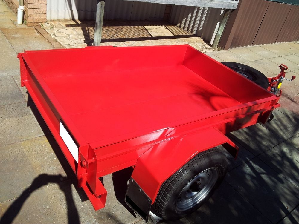 Red Utility Trailer With Black Tires, on a Sunny Day — Mid Coast Smash Repairs In Mid North Coast, NSW