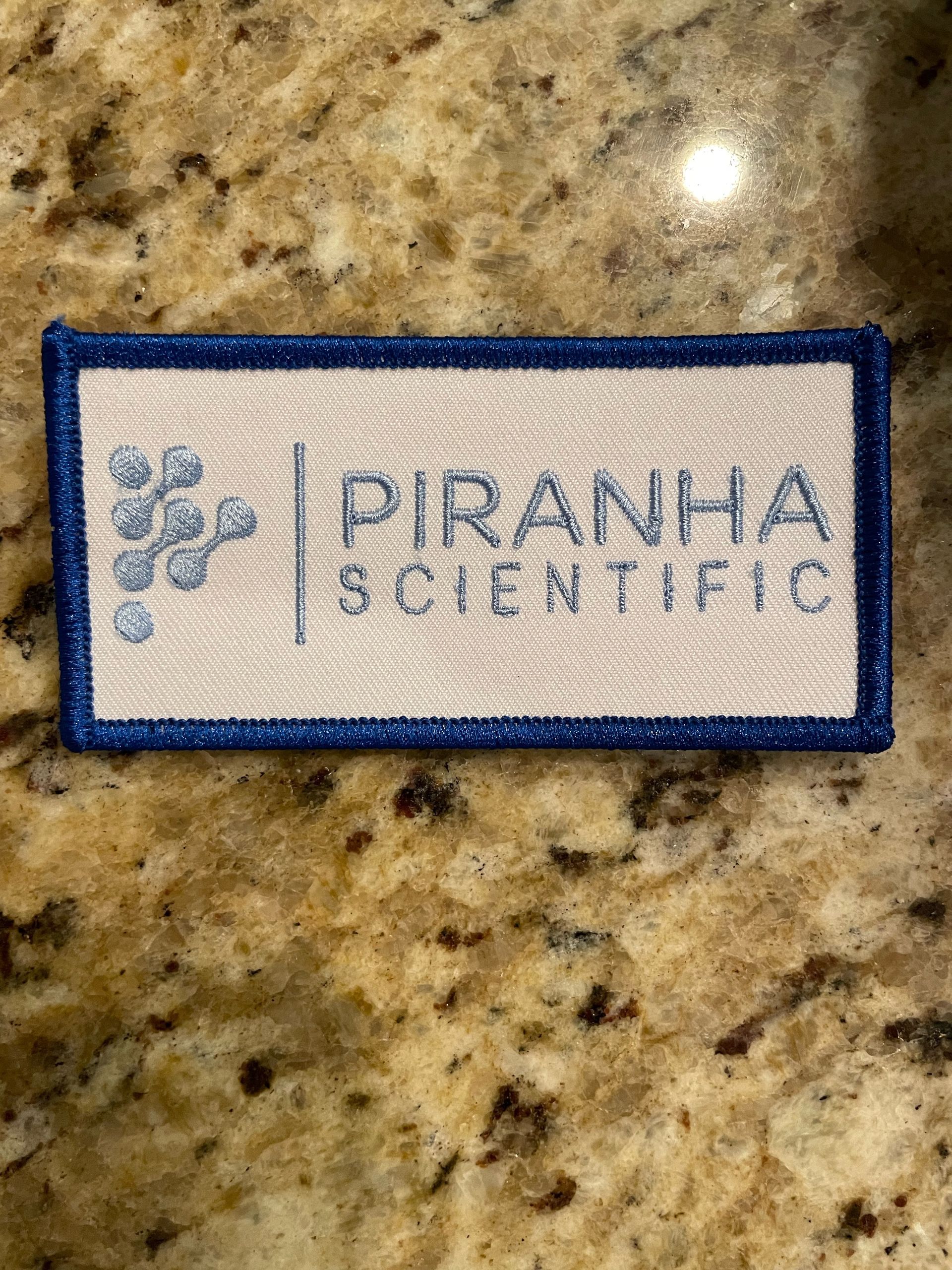 Piranha Scientific embroided logo