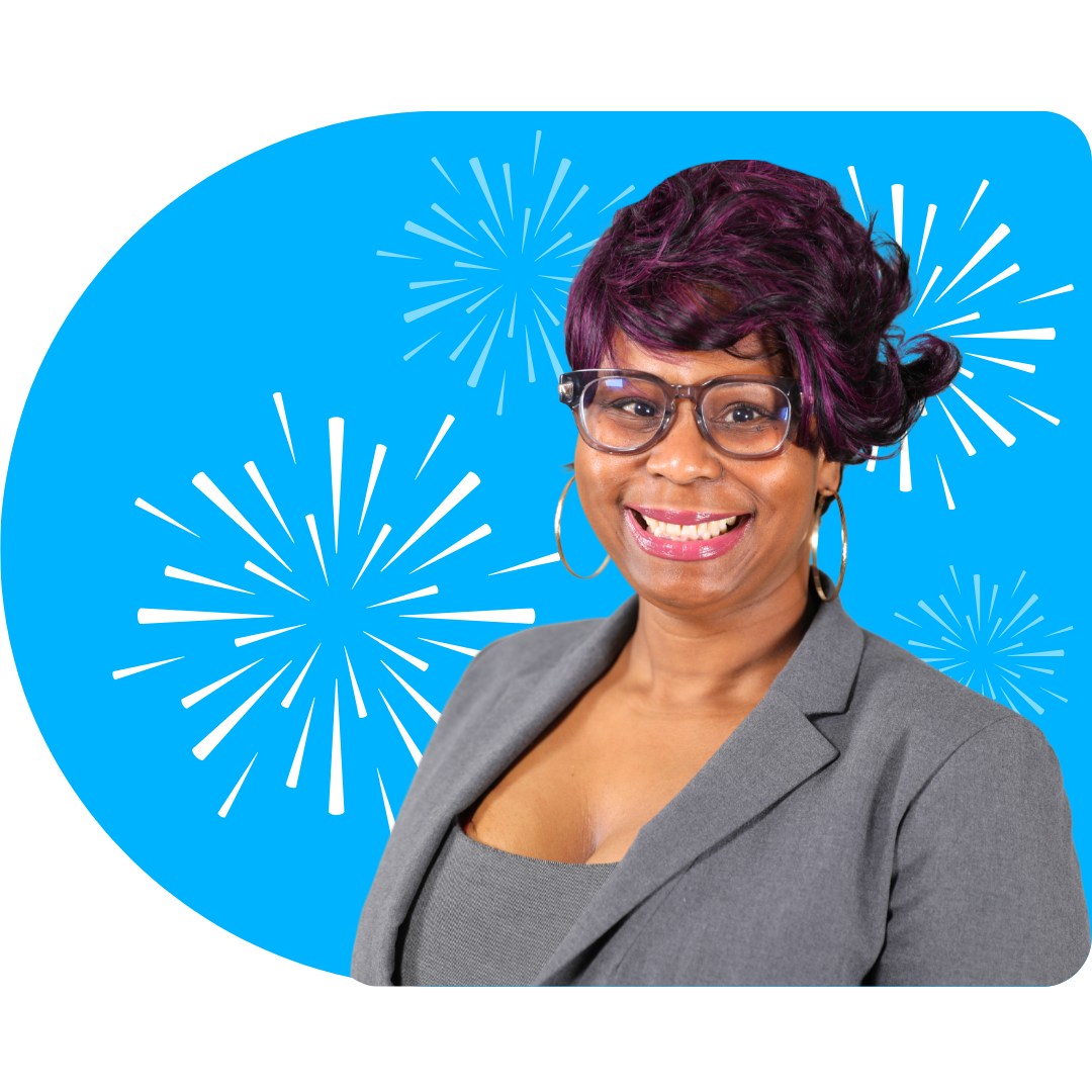 A person with blonde highlights, wearing a black blazer and necklace, posing against a blue background with white fireworks.