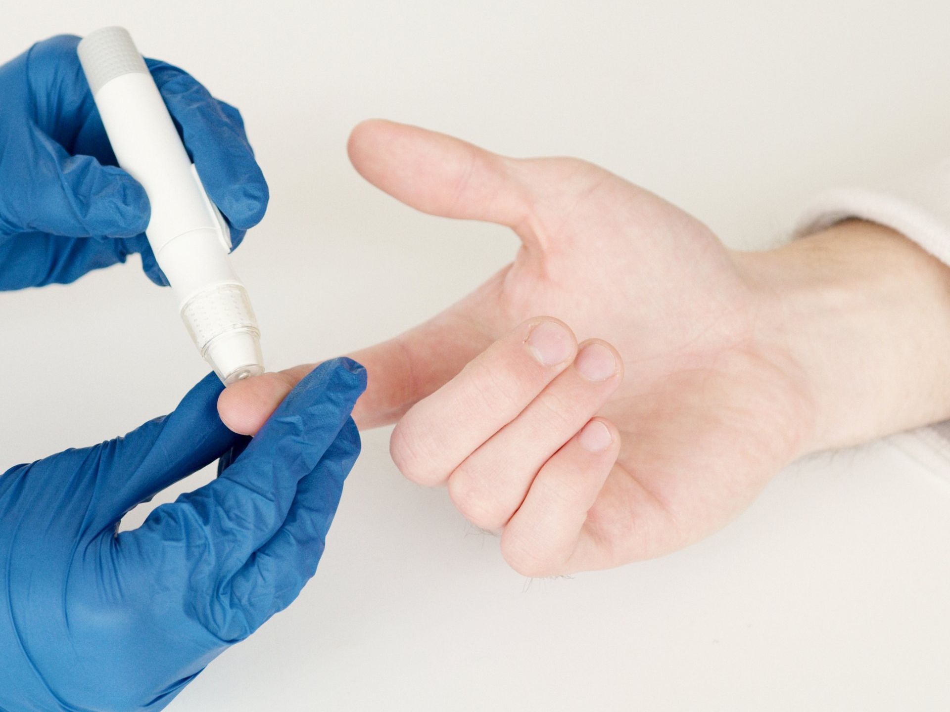 Houston TX diabetes doctor pricking patients finger