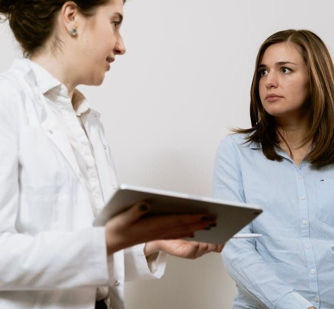 Houston TX woman's doctor talking to patient