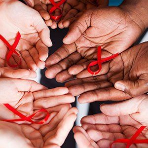 Hands holding ribbons for HIV Month in Houston TX