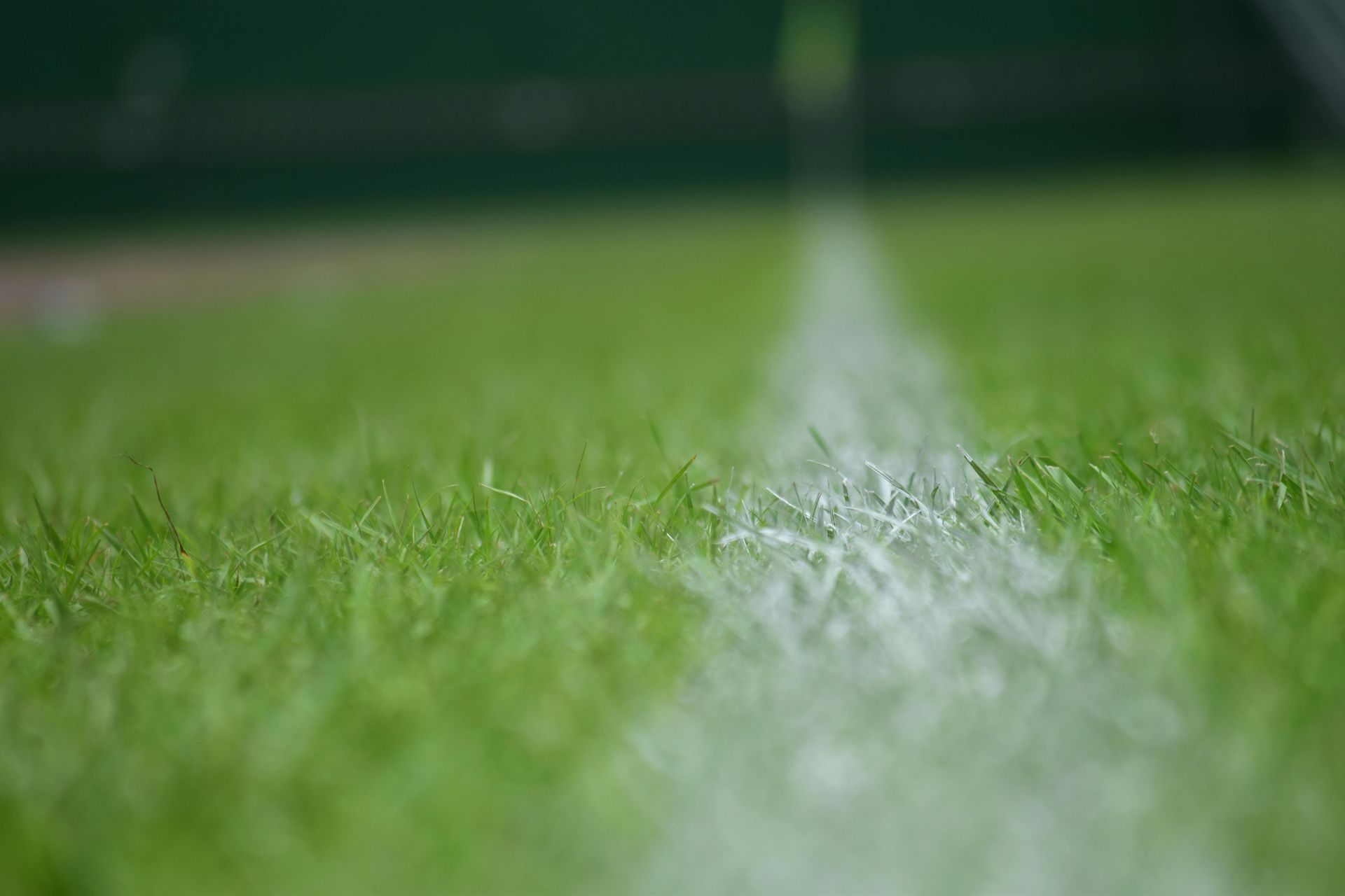 A close up of a white line on a tennis court.