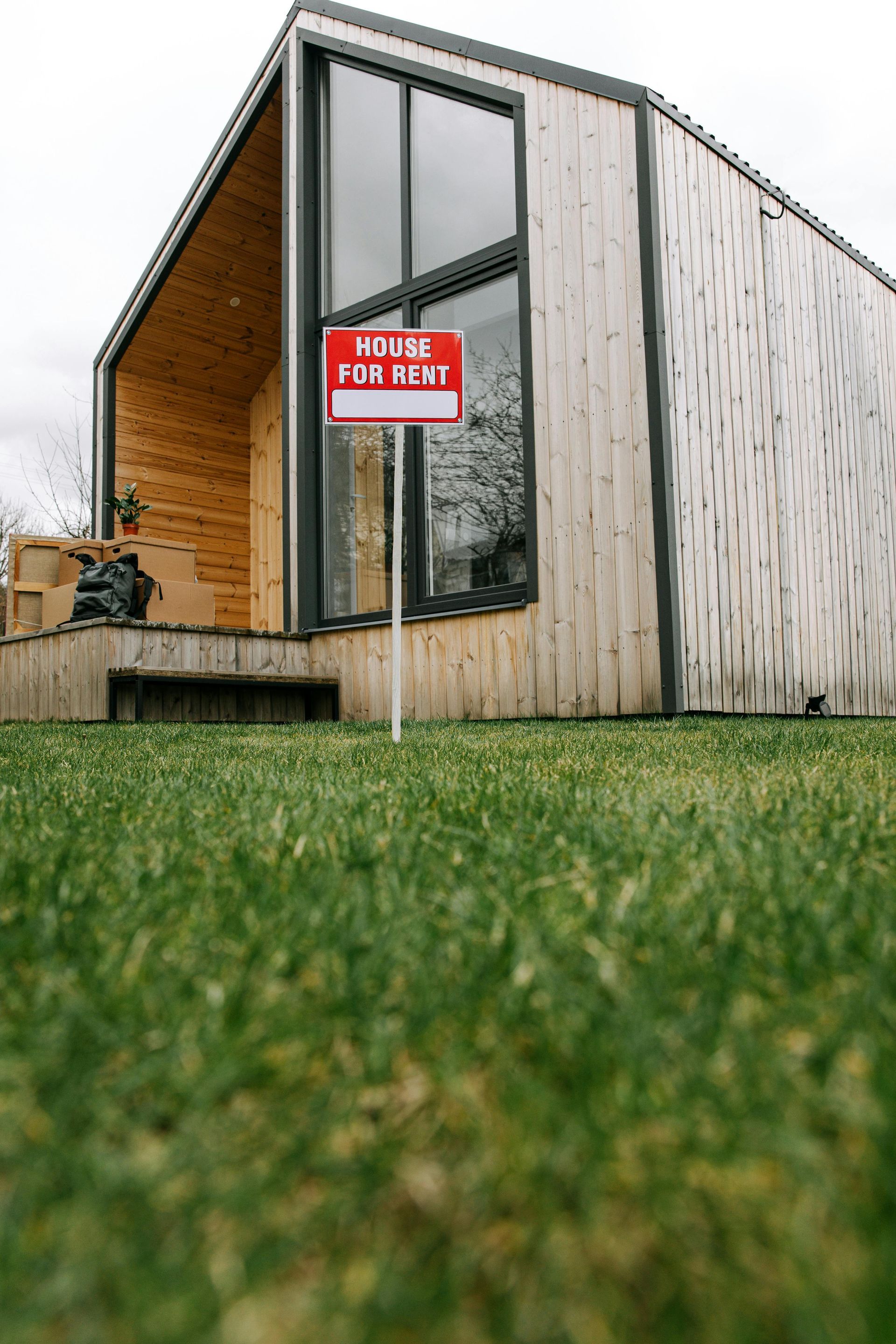 A house with a for sale sign in front of it.