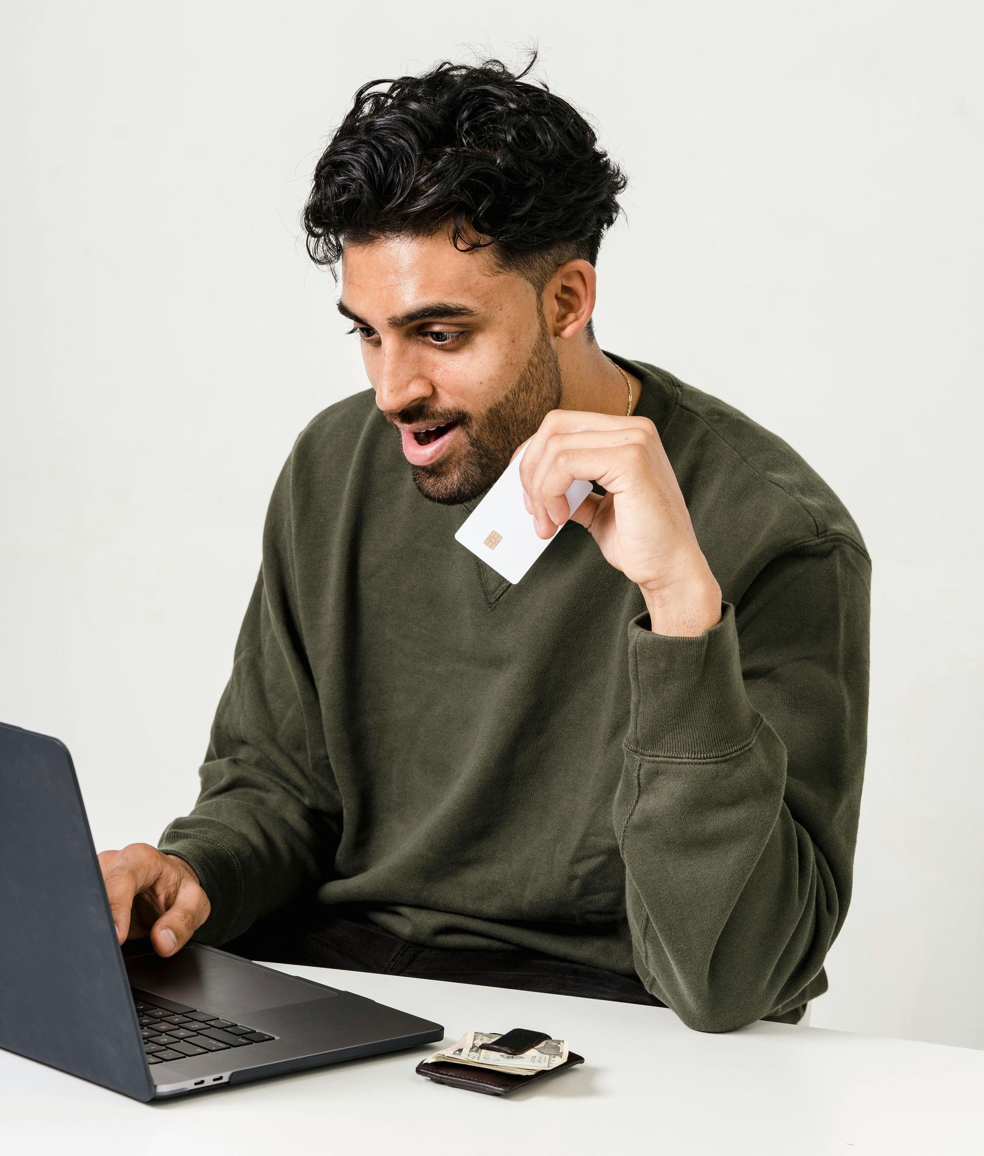 A person sitting at a desk, looking impressed while viewing a computer screen, conveying trust and authority.