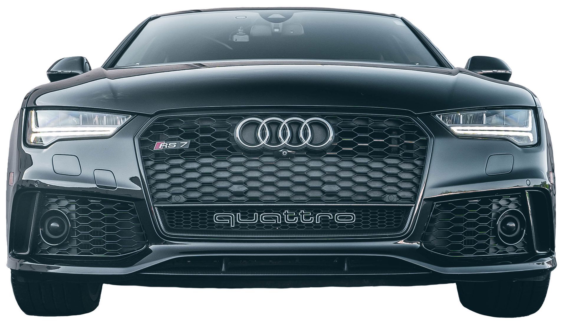 the front of a black audi rs7 is shown on a white background .