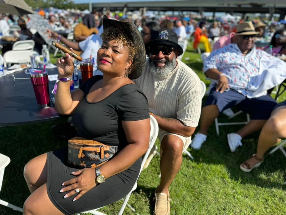 A jazz band performing: trumpet player, bassist, drummer, and keyboardist on stage indoors.