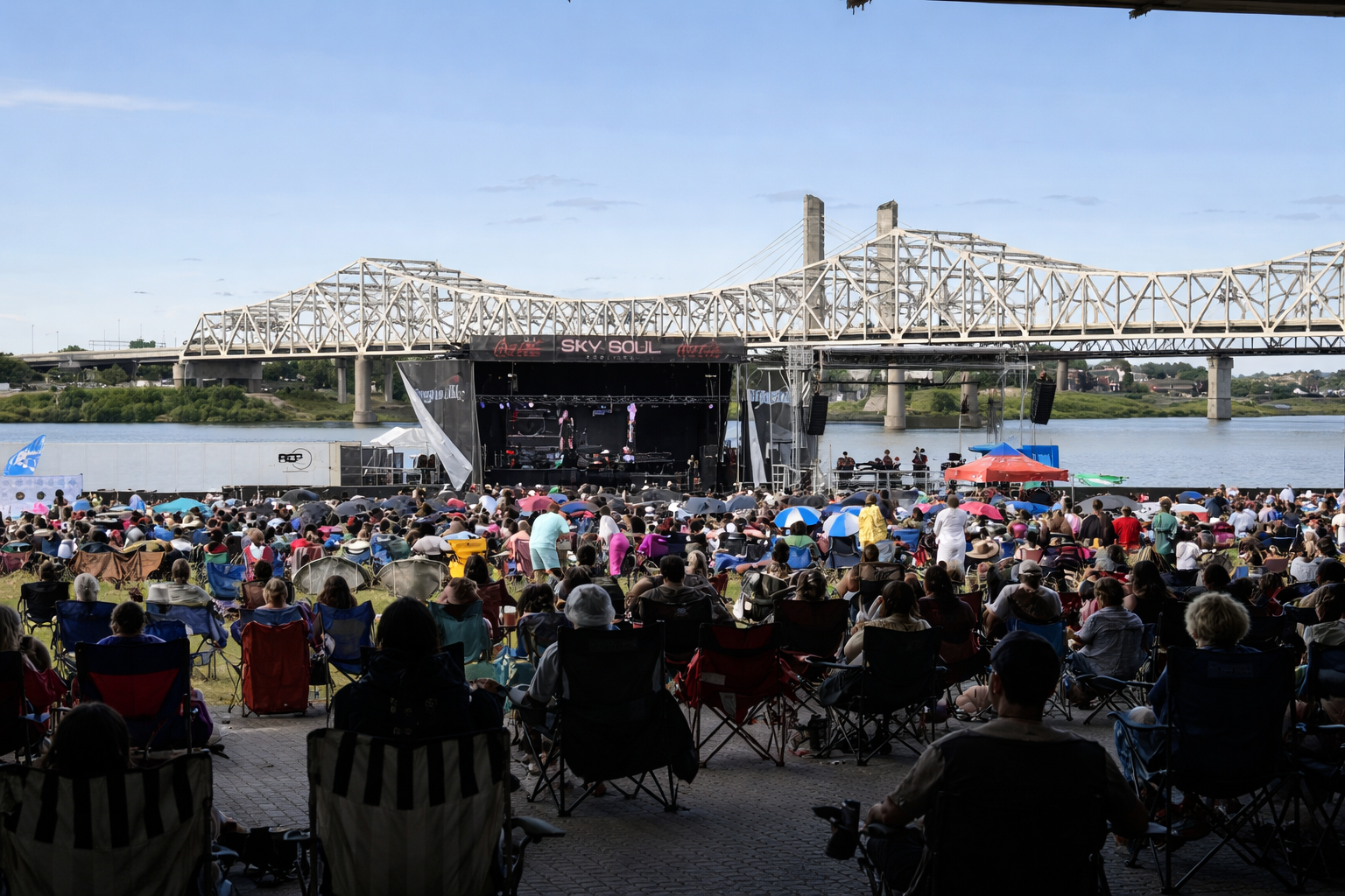 A stage performance with a singer, band, and a projection of a black and white photo of a singer.