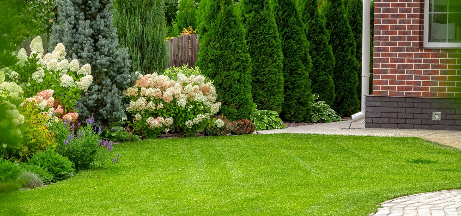 Beautiful landscaped garden with palm trees — J & M Lawn Service Tampa FL