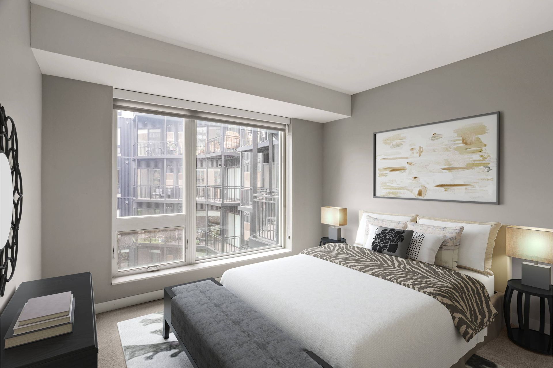 Modern bedroom here at Maverick with a white bed, patterned throw, dark bench, large window, and wall art in a neutral-toned room.