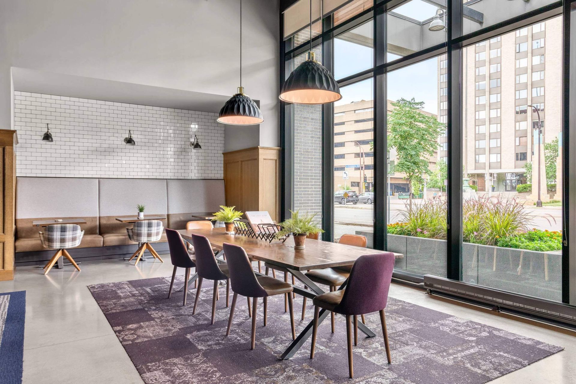 There is a large table and chairs in the middle of the room.