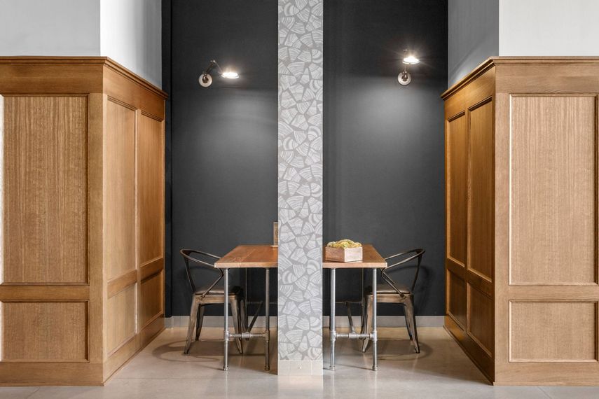 There is a table and chairs in the middle of the room.