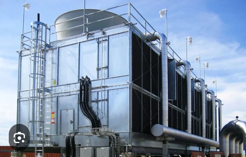 A large industrial building with a blue sky in the background