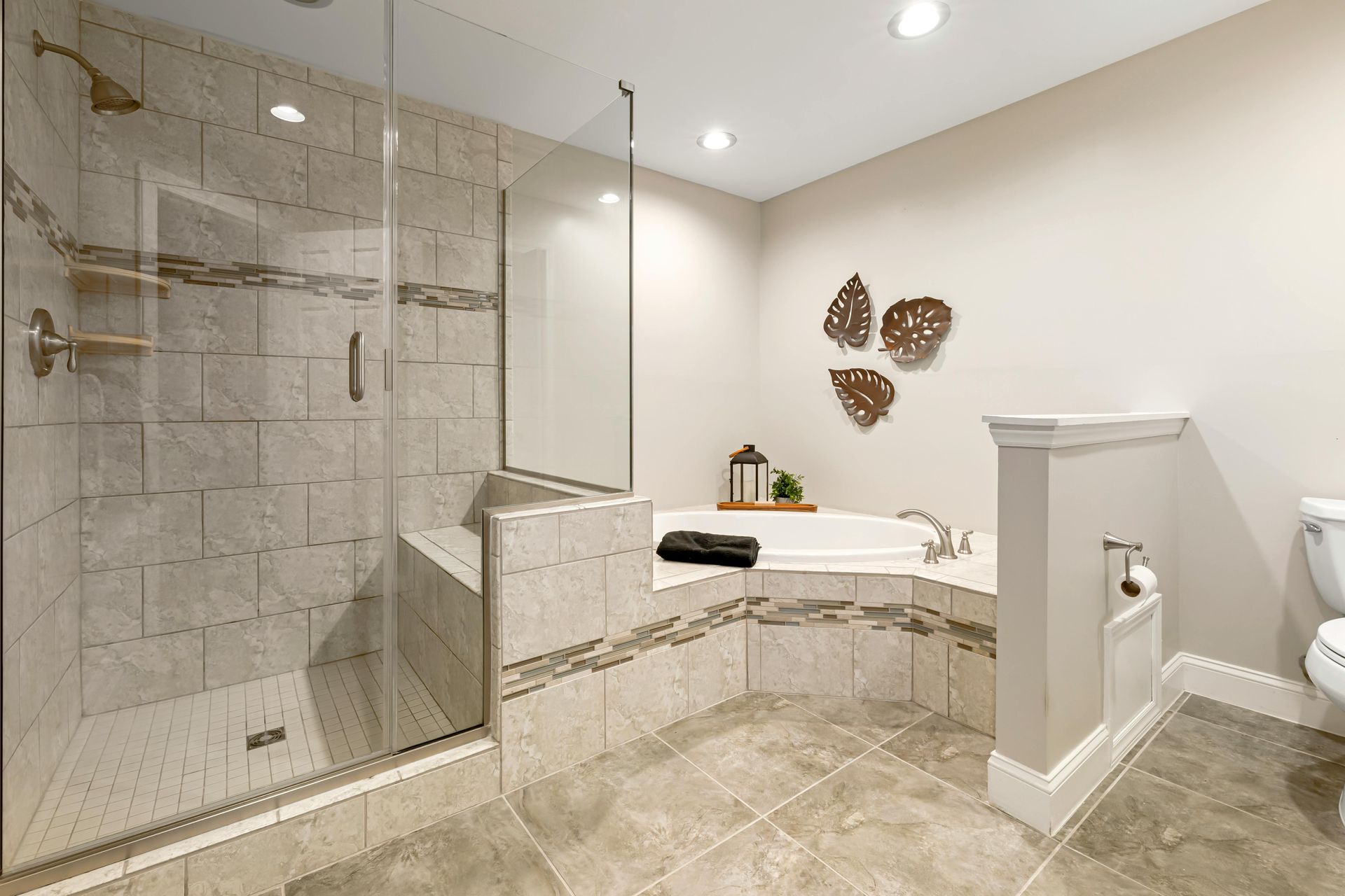 Bathroom with walk-in shower, corner bathtub, and neutral tile.